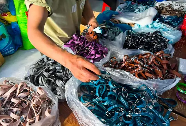 Worker Sorting Finished Lanyard Keychains by Color